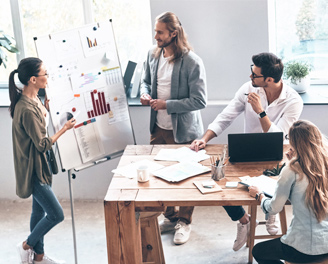 An office team exchanging ideas over an office counter